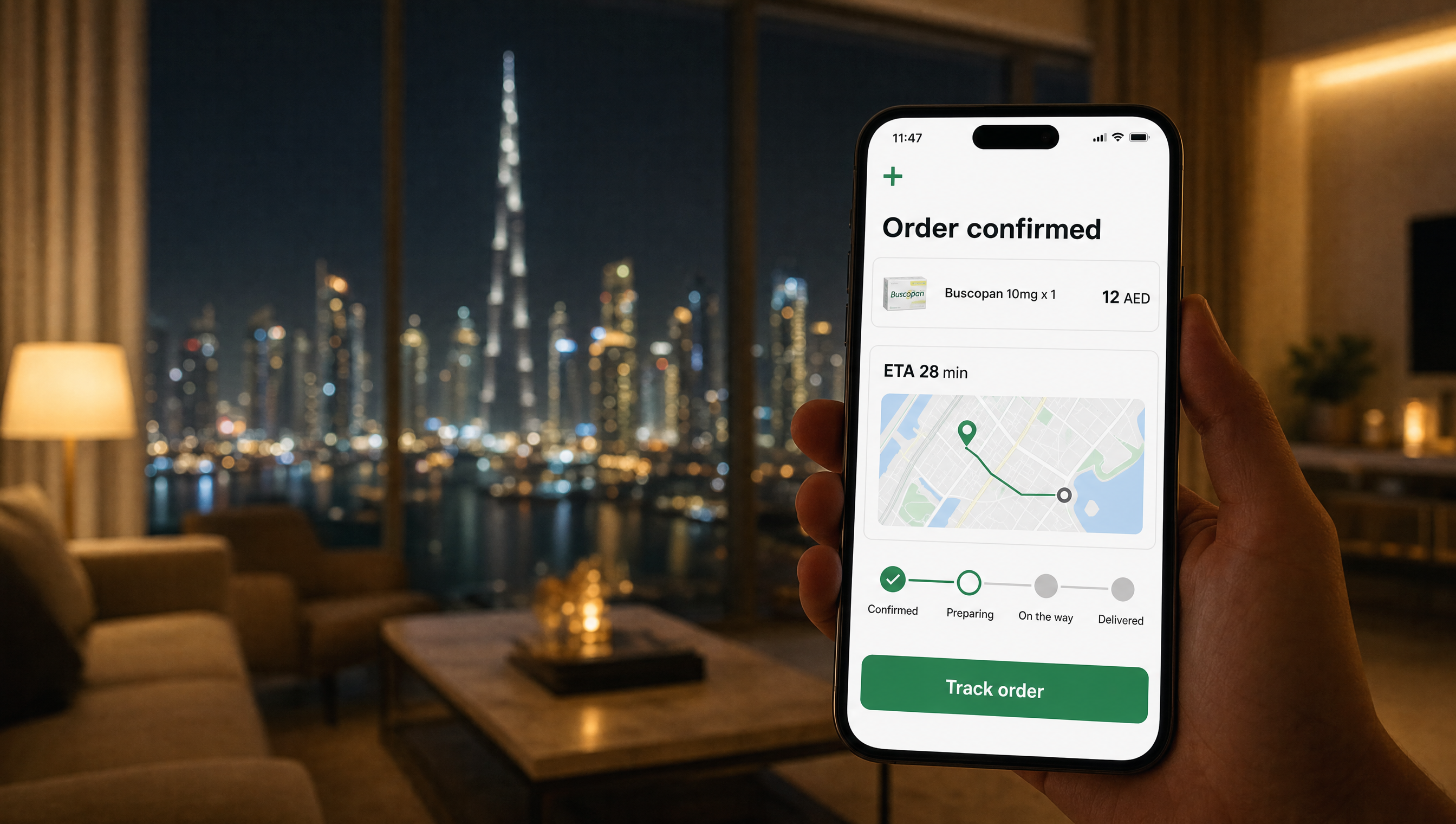 A smartphone showing a confirmed Buscopan delivery order at 11:47pm in a dim Dubai apartment